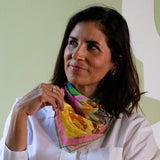 woman wearing French Roses small silk square scarf revealing yellow, pink, green and blue colours