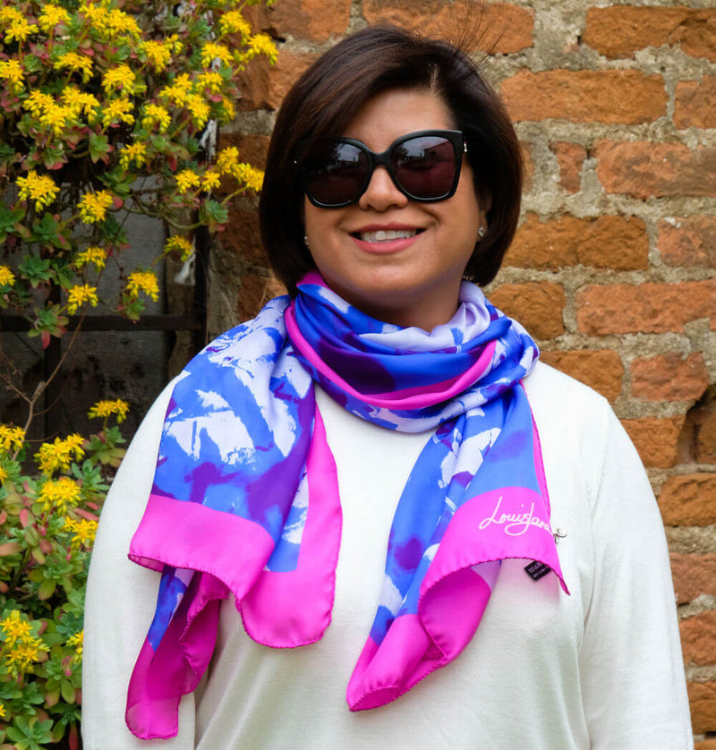 woman wearing cerulean blue and fushcia colour long silk scarf in summer branches design by Louis Jane