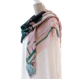 side view of extra large square silk and cashmere shawl in deep green and soft pink with Japanese orchid design