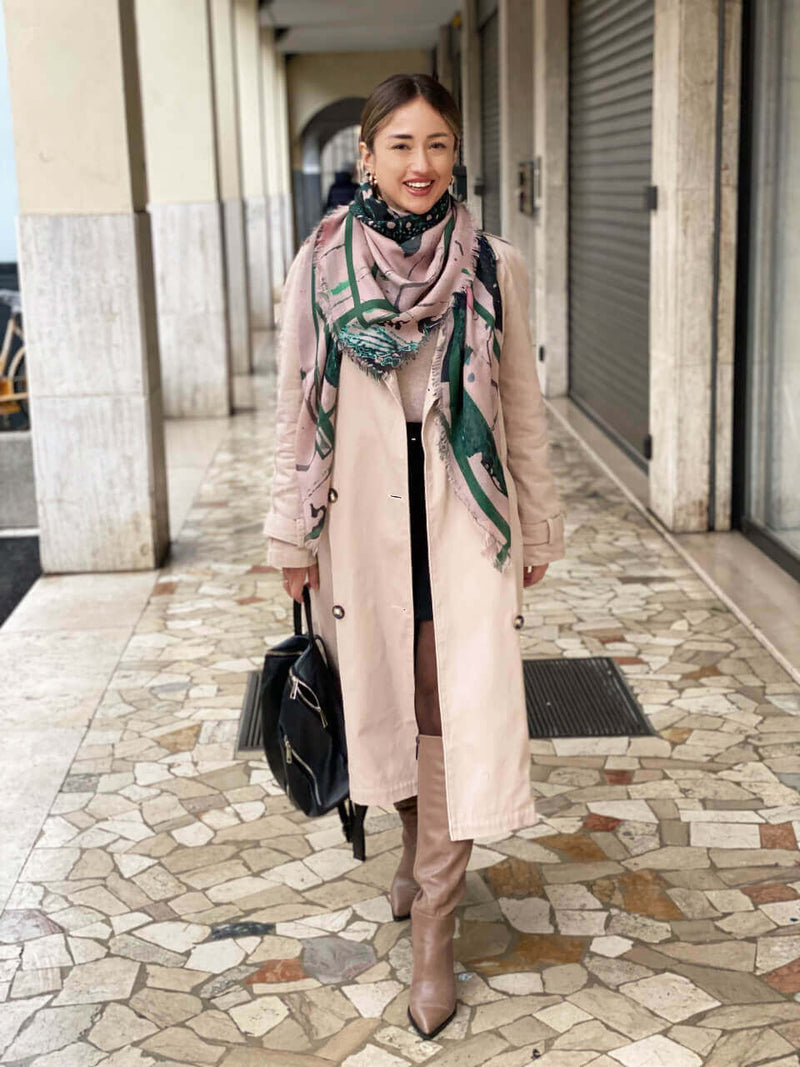 woman standing in Padova wearing Louis Jane Japanese orchid design cashmere and silk oversized square shawl in pink and holiday green