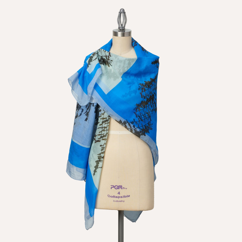 Leaves oversize silk and cotton square shawl, worn as wrap, blue colour  Edit alt text