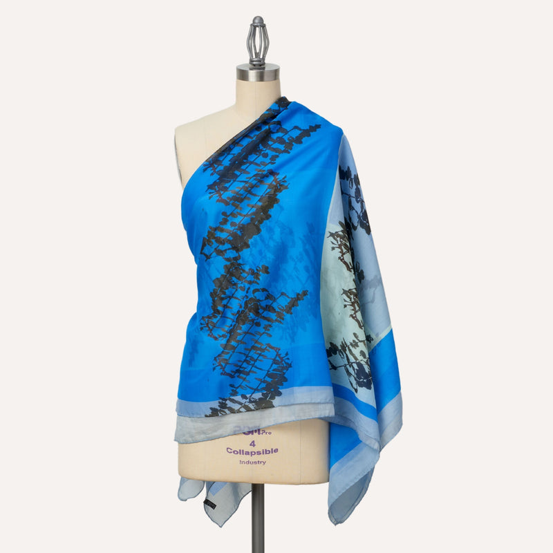 Leaves oversize silk and cotton square shawl, worn over one shoulder, blue colour  